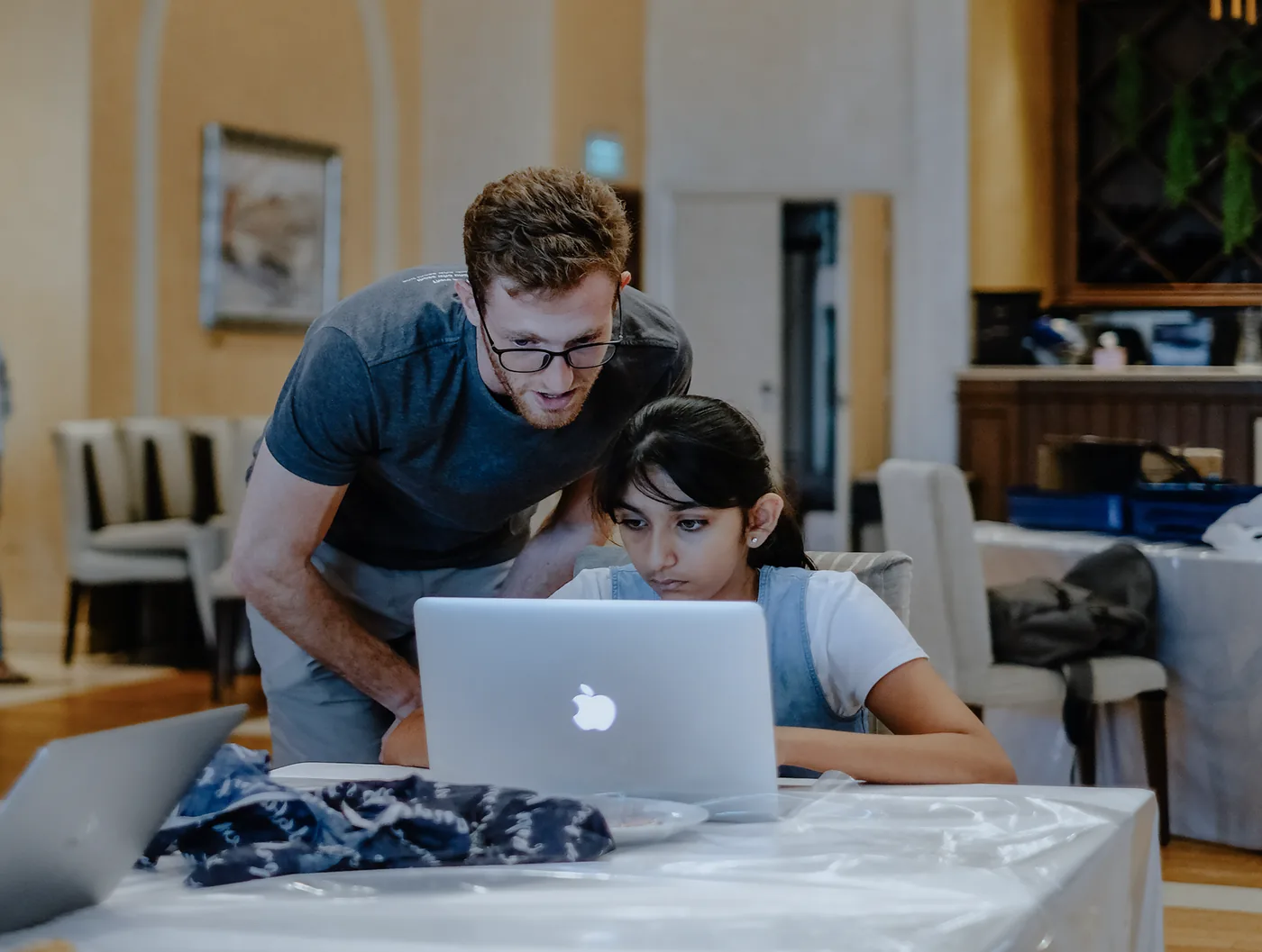 Strive teacher Tamir coding with a student on a laptop